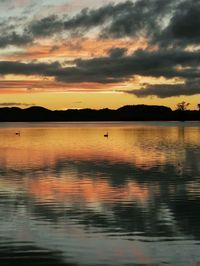 Scenic view of lake at sunset