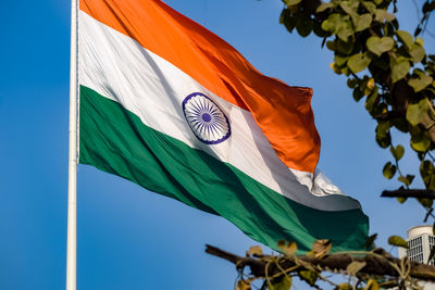 India flag flying high at connaught place with pride in blue sky, india flag fluttering, indian flag