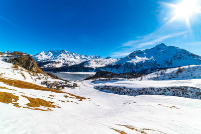 View of the village of grevasalvas, and lake sils, in engadine, switzerland, in winter.