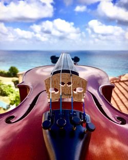 Close-up of guitar against sky