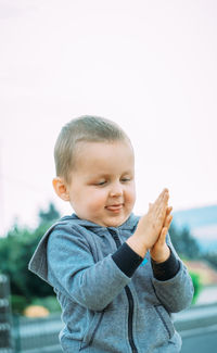 Portrait of cute baby boy against white background