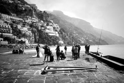 Group of people on mountain against sky