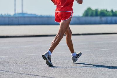 Running old man. senior man jogging in sportswear on city road. healthy lifestyle, street workout