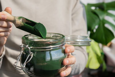 Midsection of woman holding potted plant