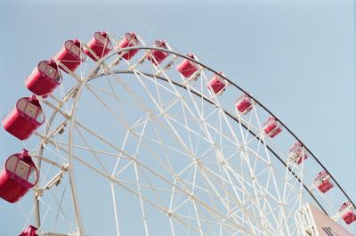 Low angle view of ferris wheel against clear sky