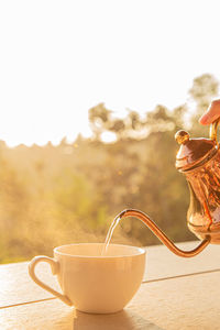 The process of brewing the tea ceremony, a cup of freshly brewed black tea, soft warm light.