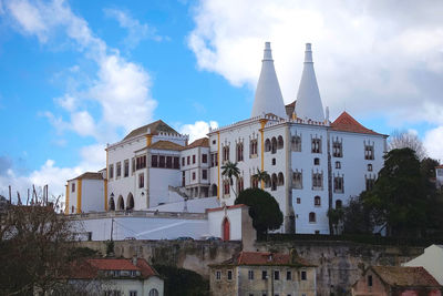 Low angle view of building against cloudy sky