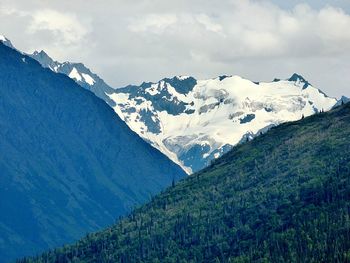 Scenic view of mountains against cloudy sky