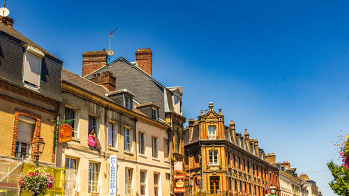 Low angle view of buildings against clear blue sky