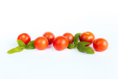 Close-up of tomatoes over white background