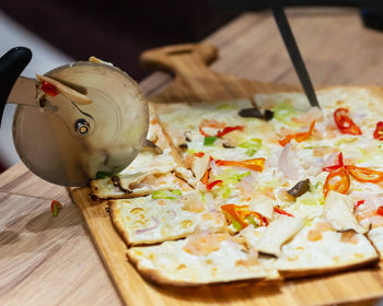 High angle view of pizza on cutting board