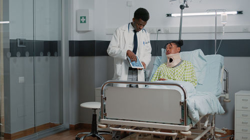 Male doctor showing medical x-ray to patient