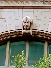 Low angle view of statue against building