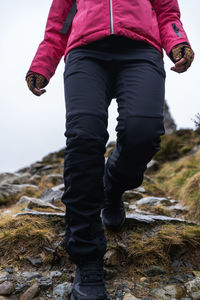 Low section of person walking on mountain