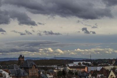 View of cityscape against cloudy sky