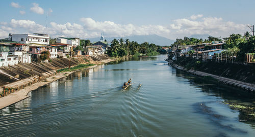 Houses by river in city