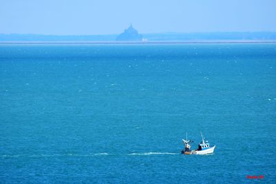 Boat sailing in sea against sky