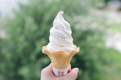 Close-up of hand holding ice cream cone