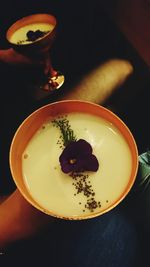 High angle view of hand holding coffee cup on table