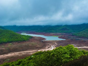 Scenic view of lake and mountains against sky