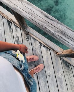 High angle view of woman hand holding wood