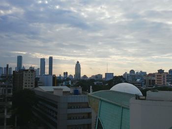 Cityscape against cloudy sky