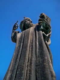 Low angle view of statue against clear blue sky