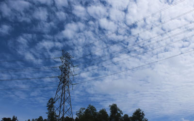 Low angle view of electricity pylon against sky