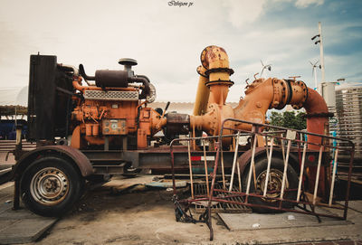 Abandoned truck on street in city against sky