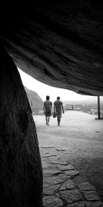 Rear view of people walking on land