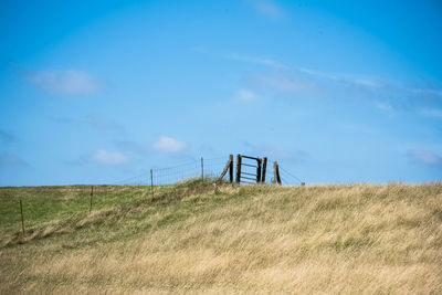 Fence on field against sky