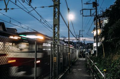 Railroad tracks against sky at night