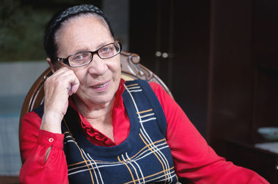 Senior woman with eyeglasses sitting at home