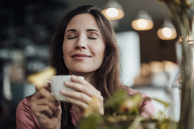 Portrait of woman drinking coffee