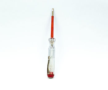 Directly above shot of red crane against white background