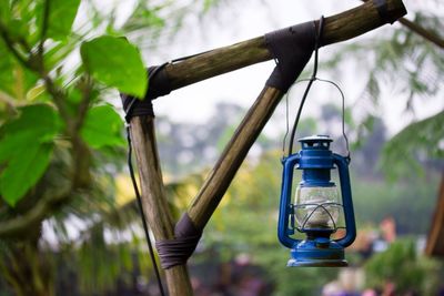 Old oil lamp hanging from bamboo