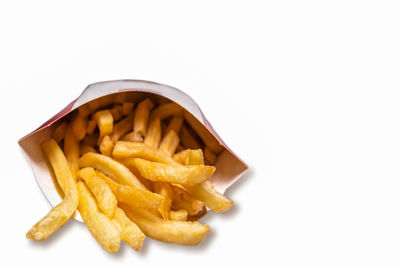 High angle view of fresh yellow and fries against white background