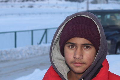Portrait of young woman in warm clothing