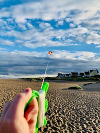 Midsection of person holding hands against sky