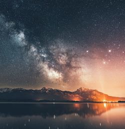 Scenic view of lake against sky at night