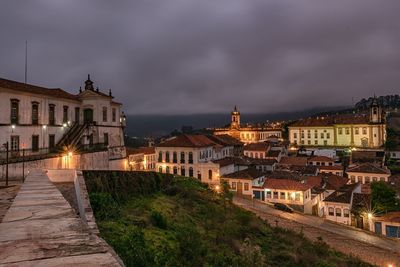 Buildings in city against sky at night