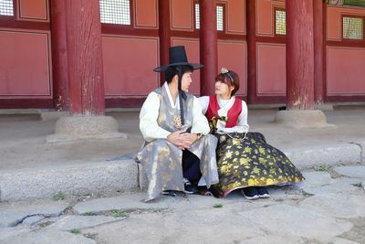 Young couple sitting outdoors