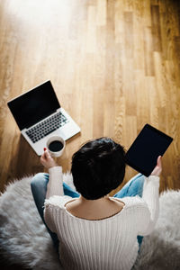 Beautiful woman holds in her hand a black tablet