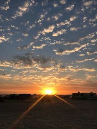 Scenic view of beach against sky during sunset