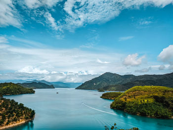 Scenic view of sea and mountains against sky