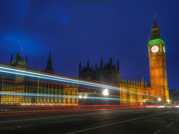 Light trails on westminster bridge in city at night