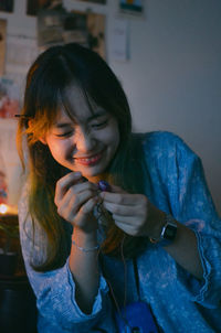 Portrait of a young woman holding camera