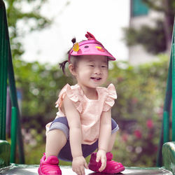 Close-up of girl crouching on play equipment