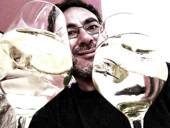 Portrait of young man drinking glass