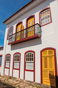 Facade view of old colored house with balcony and cobblestone in paraty,  brazil